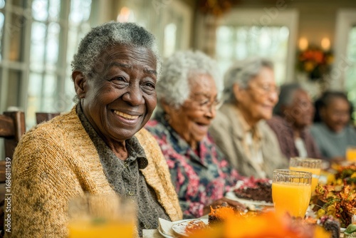 Seniors enjoying a joyful gathering around a festive table filled with food and drinks during a cozy celebration
