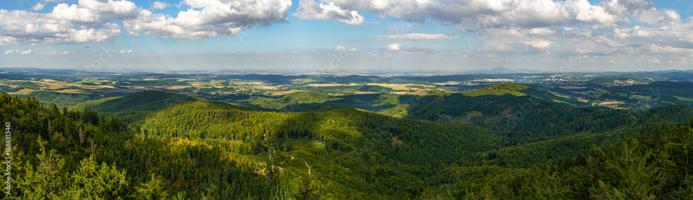 Fototapeta premium Panoramic view of the mountains and the city of Walbrzych seen from the top of the observation tower on Trojgarb Mountain near the town of Jaczków.