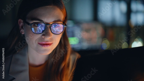 Tableau sur toile Late evening analyst examining currency fluctuations on notebook device closeup