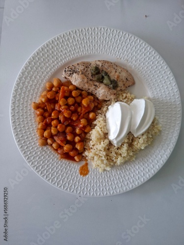 Healthy lunch meal. Chickpea. Chicken fillet, bulgur and yogurt on the plate.