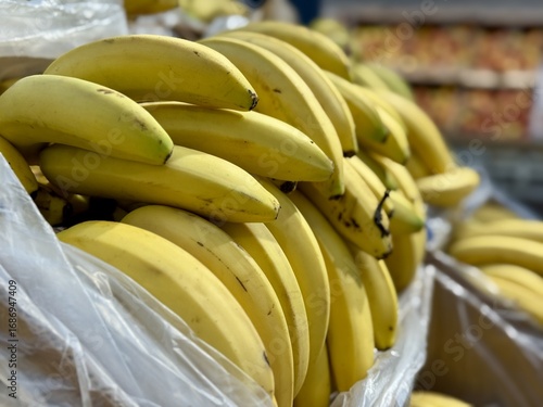 Come and discover the vibrant, eyecatching yellow bananas that are truly appealing and delightful. Vibrant and bountiful assortment of ripe, yellow bananas stacked attractively for eager sale