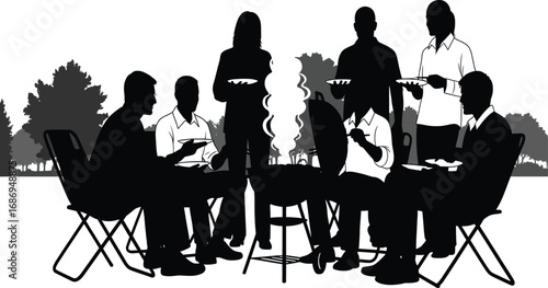 Silhouette of a group of people having an outdoor barbecue with trees in the background