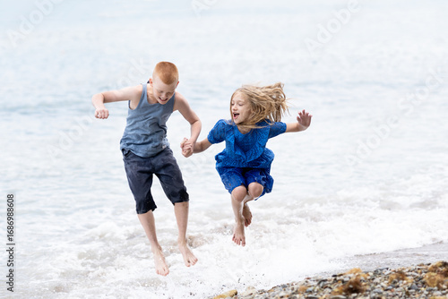 boy and girl playing with waves