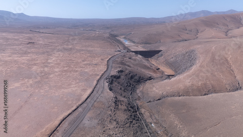 Aerial View of Desert Reservoir and Dam Structure in Arid Mountainous Landscape
