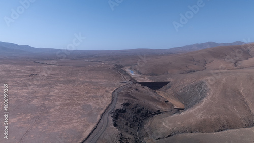 Aerial View of Desert Reservoir and Dam Structure in Arid Mountainous Landscape