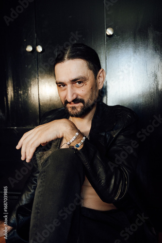portrait of a handsome man with dark hair and a black beard