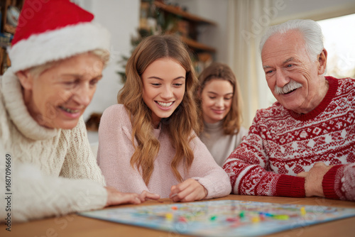 joyful family gathers around table on christmas deeply engaged in thrilling board game