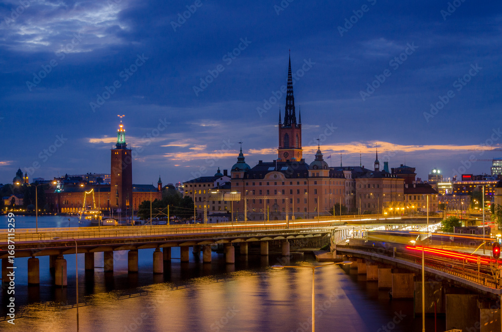 Obraz premium Stockholm 2015, Sweden - July 28, 2015: Evening View of Stockholm's Riddarholmen and City Hall Illuminated at Dusk
