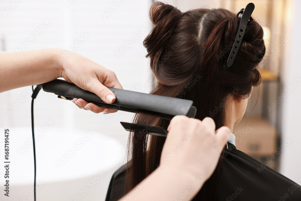 Fototapeta premium Hairdresser laminating woman's hair in salon, closeup
