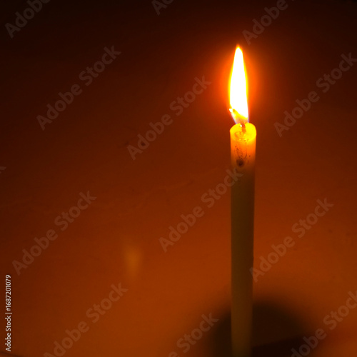 Burning candle light glowing flame