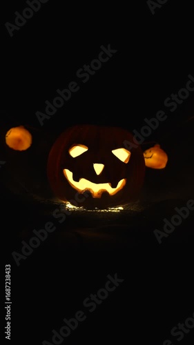 pumpkin with burning eyes in smoke for halloween