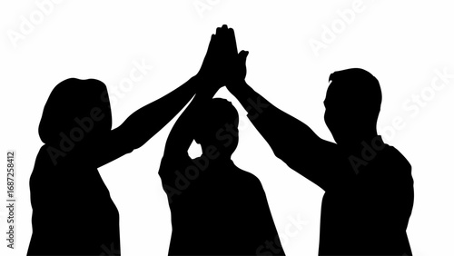Three people in silhouette giving a high five against a white background showing teamwork and collaboration