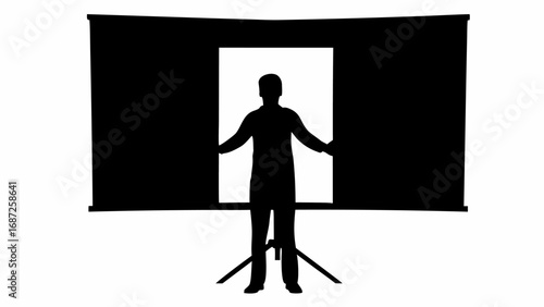 Silhouette of a person standing in front of a projector screen with arms outstretched in a dark room