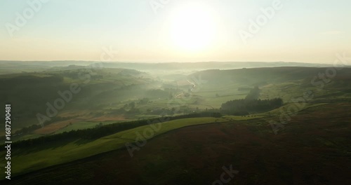 Sunrise over misty valley and moorland
