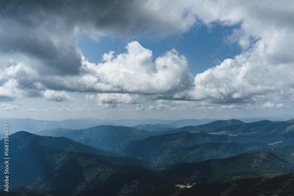 Fototapeta premium clouds over the ukrainian carpathian mountains view from hoverla peak highest in the country with green beautiful valleys in summer 
