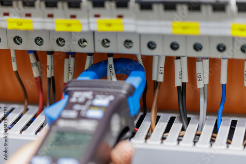 Clamp Meter Measuring Current in Control Cabinet