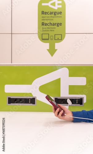 I charge my device at a charging point at the airport.