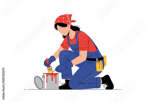 A skilled craftswoman meticulously applies fresh paint using a brush to a can while kneeling down wearing protective gloves and a bandana