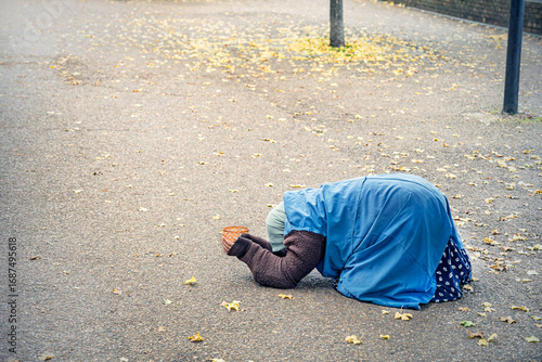Unknown beggar woman begging with a basket in London, UK.
Poverty is also a hard issue in big, developed cities.