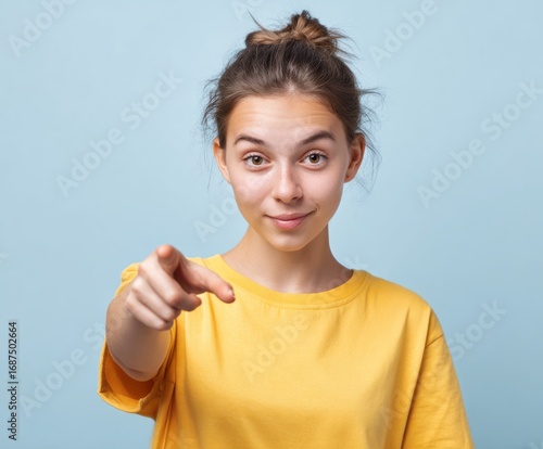 Wallpaper Mural A young woman in a bright yellow shirt directs attention directly forward with a confident and engaging expression. Torontodigital.ca