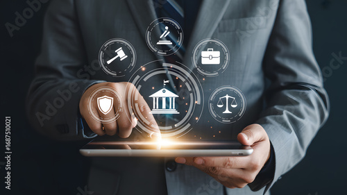 Legal professional interacts with digital courtroom icons on tablet, symbolizing justice and law services