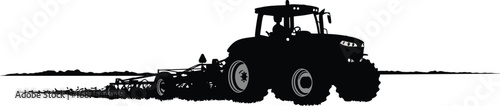 a tractor plowing field under clear sky