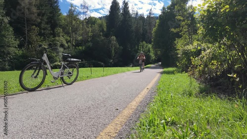 pretty beautiful senior woman riding her electric mountain bike on Dolomites,