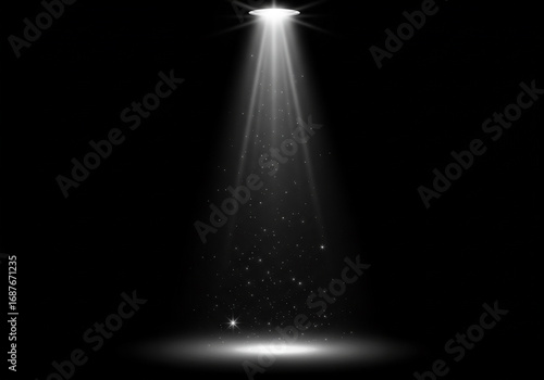 A bright spotlight shines down on a dark stage.