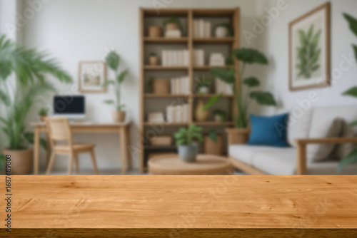 empty wooden table top blurred view of modern living room with sofa and soft bench. room interior with couch, armchair and coffee table or shelving units. stylish living room. comfortable workplace.