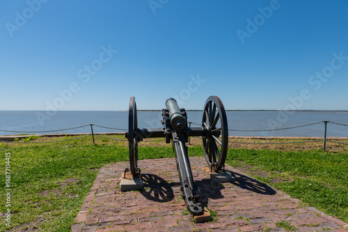 A Civil War field cannon on wheels overlooks Charleston Harbor at Fort Sumter National Monument.