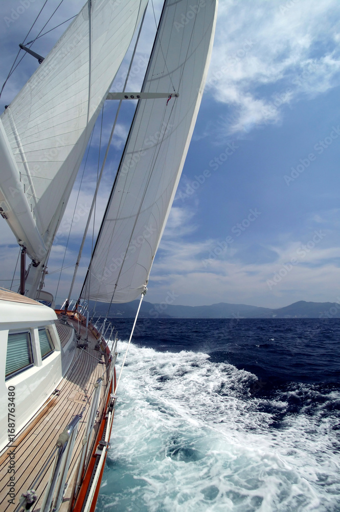 Fototapeta premium Luxury sailing yacht navigating waves in Phuket's regatta for ultimate relaxation and adventure