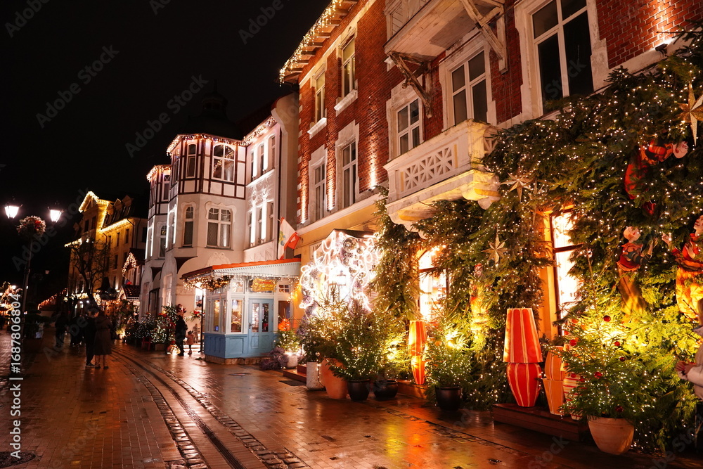 Fototapeta premium Charming historic street with beautiful Christmas decorations and festive lighting. Christmas in Europe