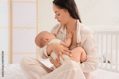 Mother rocking her baby to ...