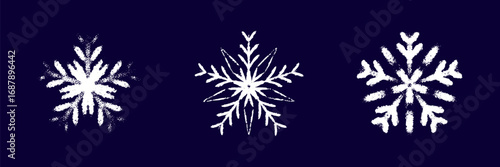 Childish snow flake white chalk drawing on dark blue blackboard. Crayon, pastel whimsical snowflakes hand drawn scribbles. Merry Christmas and Happy New Year winter design elements