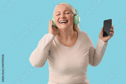Senior woman in headphones ...