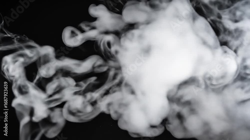 Billowing clouds of white smoke against solid black backdrop