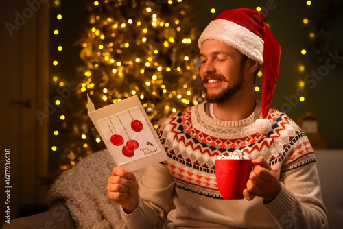Young man in Santa hat with...