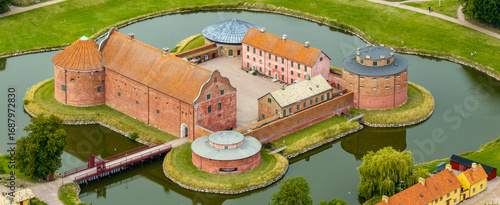 Photography Aerial close up view of Landskrona castle made of brick, protected by water fill