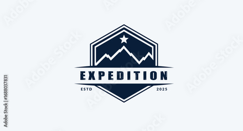 Dark blue hexagonal expedition badge logo with stylized mountains and star
