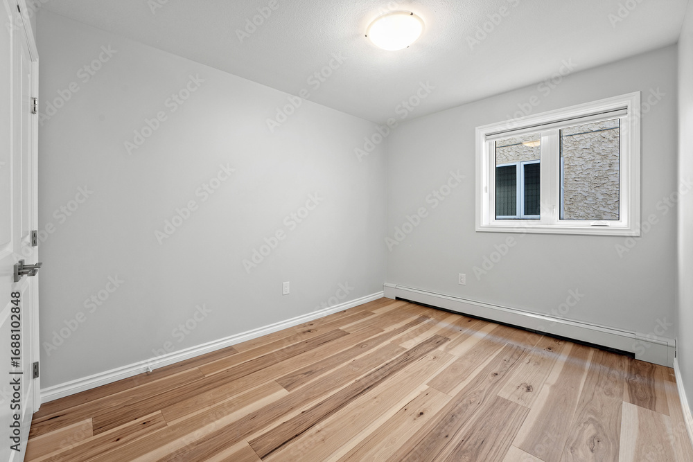 Fototapeta premium Very clean and empty room with a white wall and wooden floors
