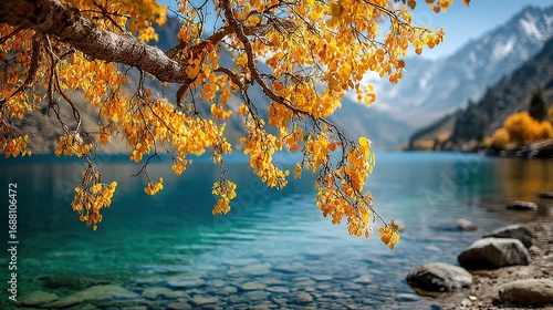 Yellow Leaves Branch Near Blue Lake and Mountains. Scenic and Peaceful Nature Scene. Autumnal and Serene Landscape.