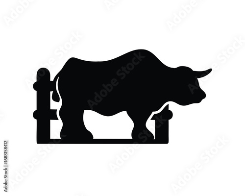 Silhouette of a Bull Leaning Over a Fence in Stark Contrast