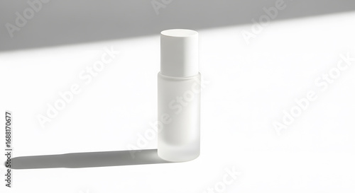 Minimalist mockup of a frosted glass rollerball bottle for serum or perfume with hard sunlight and shadow on a white background.