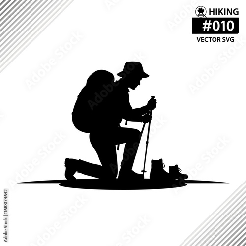 Determined hiker kneels with backpack and trekking poles, pausing during an adventurous mountain journey