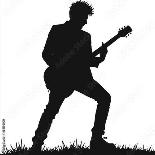 Black silhouette of a man playing electric guitar on grass
