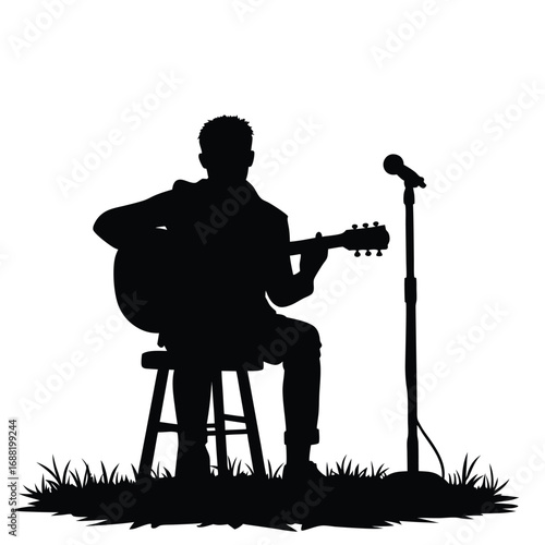 Man playing acoustic guitar on stool with microphone