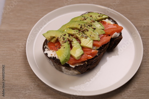Delicious breakfast toast of wholegrain bread with smoked salmon cream cheese and avocado.