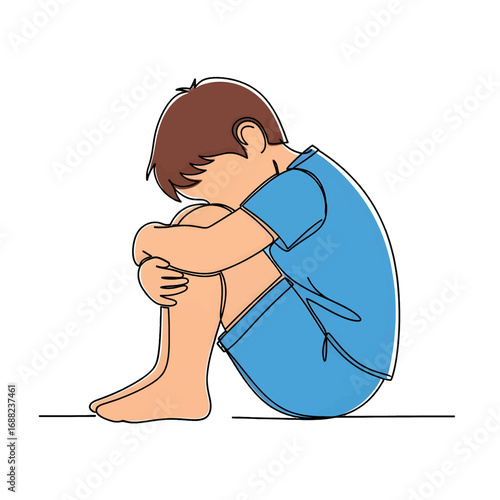 Sad Brown Haired Boy in Blue Outfit Sitting With Head On Knees Against White Background