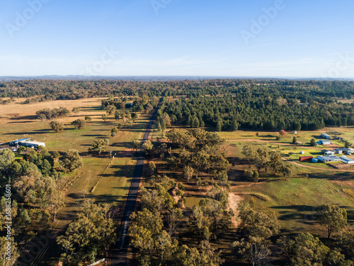 Rural farm properties on outskirts of Dubbo beside unmarked road seen from aerial view