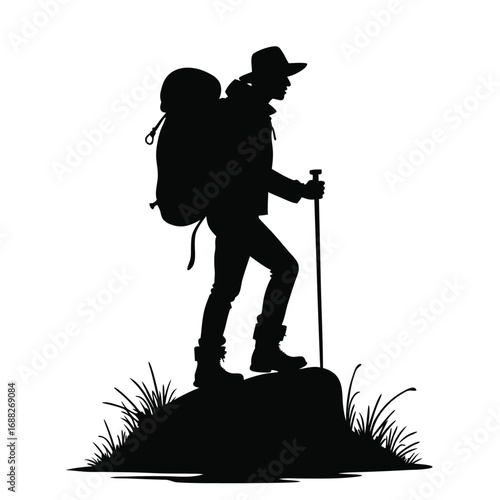 Silhouette hiker with backpack and trekking pole on rock